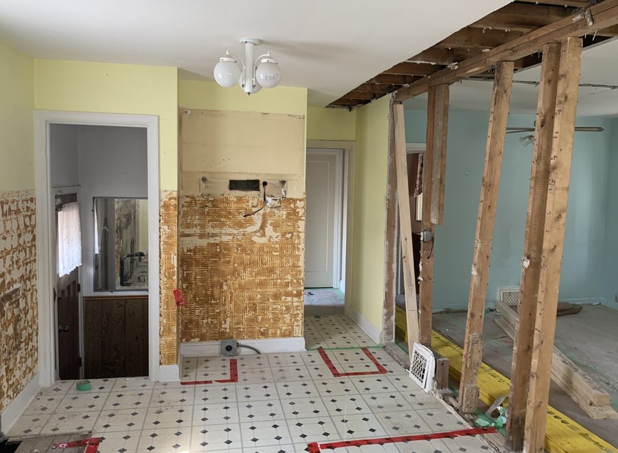 Interior demolition with temporary shoring posts holding a removed bearing wall